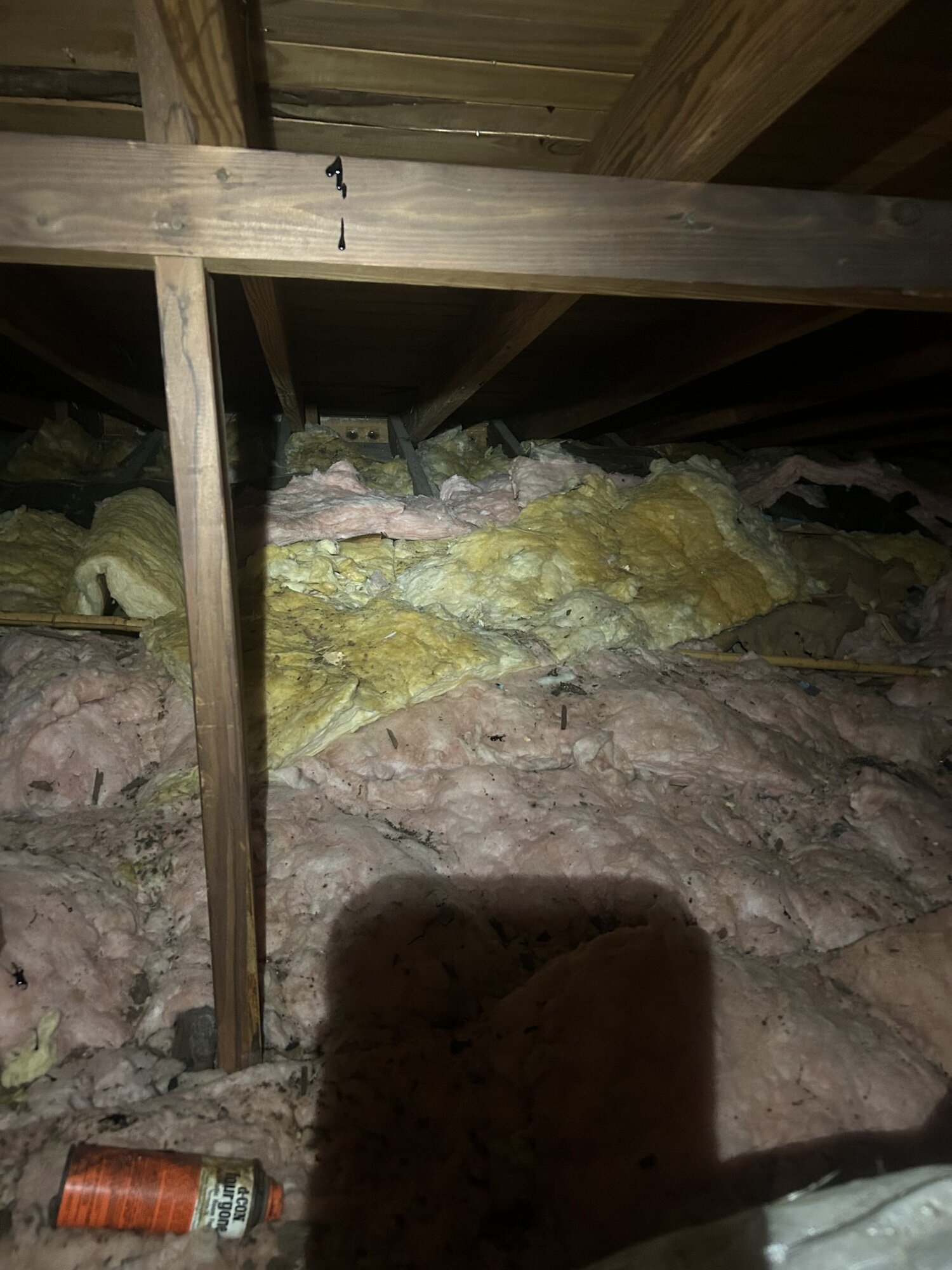 Old compressed attic insulation before removal