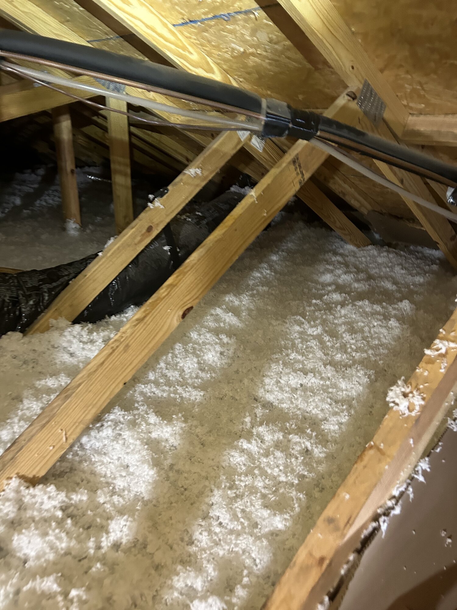 Completed blown-in attic insulation in a Panama City home